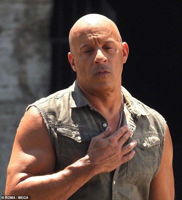 Vin Diesel is cooled down by fan waving assistants as actor gets caught ...